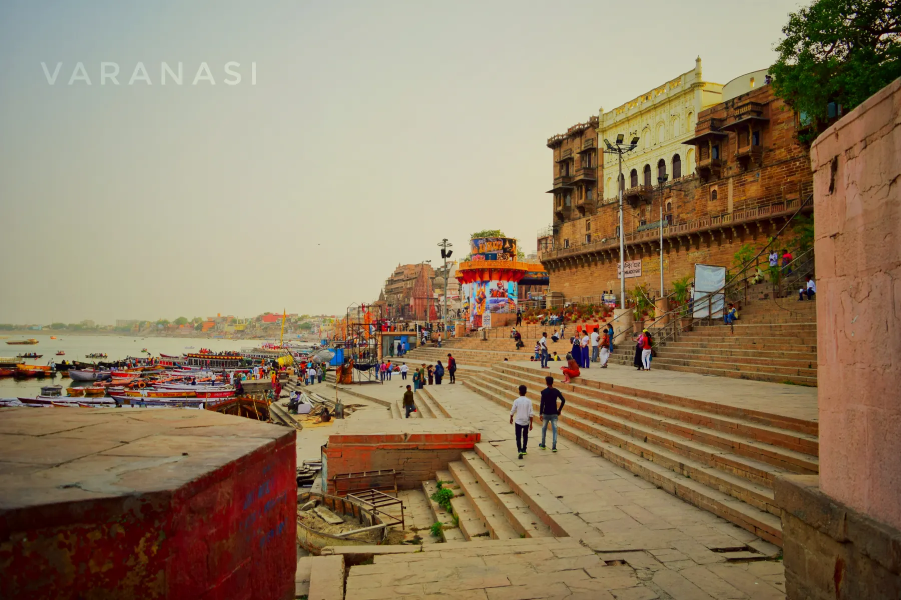 Old palaces above wide ghat steps in the evening